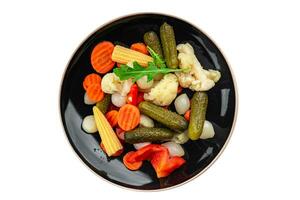 vegetables pickled salad spicy cucumber, gherkin, carrot, onion, cauliflower, pepper appetizer meal food snack on the table copy space food background rustic top view photo