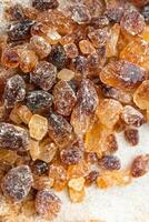 cane sugar rock sugar crystals pieces candy brown sugar candied sugar big rock caramel eating appetizer meal food snack on the table copy space food background rustic top view photo