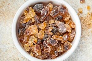 cane sugar rock sugar crystals pieces candy brown sugar candied sugar big rock caramel eating appetizer meal food snack on the table copy space food background rustic top view photo