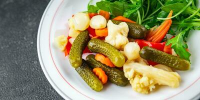 salad vegetable pickled tasty spicy cucumber, gherkin, carrot, onion, cauliflower, pepper appetizer meal food snack on the table copy space food background rustic top view photo