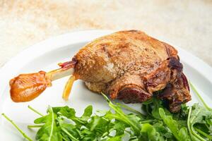 duck leg confit with berry sauce poultry meat second course vegetable delicious healthy eating cooking appetizer meal food snack on the table copy space photo