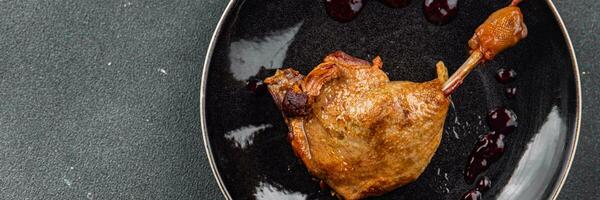 duck leg confit with berry sauce poultry meat second course vegetable delicious healthy eating cooking appetizer meal food snack on the table copy space photo