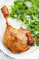 duck leg confit with berry sauce poultry meat second course vegetable delicious healthy eating cooking appetizer meal food snack on the table copy space photo