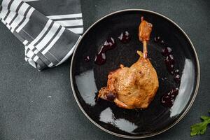 duck leg confit with berry sauce poultry meat second course vegetable delicious healthy eating cooking appetizer meal food snack on the table copy space photo