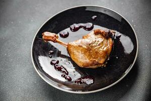 duck leg confit with berry sauce poultry meat second course vegetable delicious healthy eating cooking appetizer meal food snack on the table copy space photo