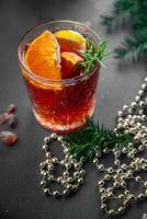 christmas mulled wine cocktail citrus and rosemary traditional drink new year holiday appetizer meal food snack on the table copy space food background rustic top view photo