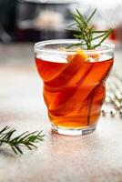 christmas mulled wine cocktail citrus and rosemary traditional drink new year holiday appetizer meal food snack on the table copy space food background rustic top view photo