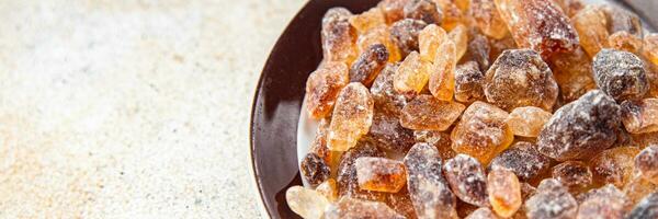 cane sugar crystal rock pieces candy brown sugar candied big rock caramel crystals sugar  taste eating cooking appetizer meal food snack on the table copy space food background rustic top view photo