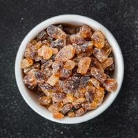 cane sugar crystal rock pieces candy brown sugar candied big rock caramel crystals sugar  taste eating cooking appetizer meal food snack on the table copy space food background rustic top view photo