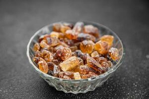 cane sugar crystal rock pieces candy brown sugar candied big rock caramel crystals sugar  taste eating cooking appetizer meal food snack on the table copy space food background rustic top view photo