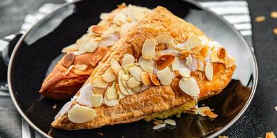 sweet almond triangle cake cream puff pastry dessert eating cooking appetizer meal food snack photo