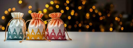 Reusable fabric gift bags with festive prints isolated on a gradient background photo