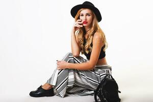 Seductive blonde woman posing in studio. Fashion portrait of elegant  model in pastel  casual  spring outfit. photo