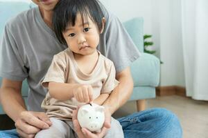 Save money. children putting coin for saving. wealth, Finance, insurance, investment, education, future, plan life, learn, banking, family, health, health and accident insurance. photo