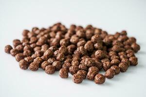 sweet crunchy chocolate children's breakfast chocolate balls on a white background photo