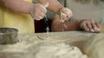 Child's hands sprinkle flour on the dough while baking.Dough Cooking,Child Education,Home Food,Sweet Pastries. video