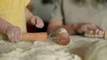 The child rolls out the dough on the table using a roller.Dough Cooking,Child Education,Home Food,Sweet Pastries. video