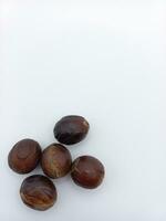 Five Whole Nutmeg isolated On White Background. Bottom Left Corner Position With Negative Space photo