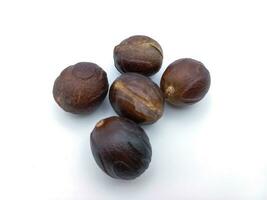 Five Whole Nutmeg isolated On White Background photo