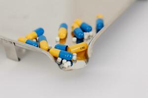 Macro Shot of colour Pills and Capsules During Production and Packing Process on Modern Pharmaceutical Factory. Tablet and Capsule Manufacturing Process. Close-up Shot of Medical Drug Production Line. photo