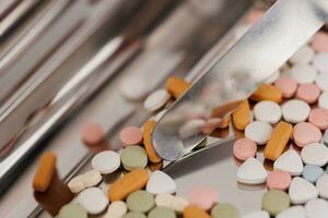 Macro Shot of colour Pills and Capsules During Production and Packing Process on Modern Pharmaceutical Factory. Tablet and Capsule Manufacturing Process. Close-up Shot of Medical Drug Production Line. photo