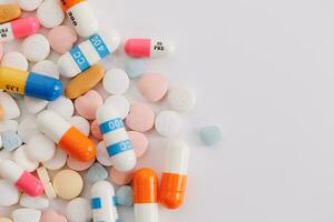 Macro Shot of colour Pills and Capsules During Production and Packing Process on Modern Pharmaceutical Factory. Tablet and Capsule Manufacturing Process. Close-up Shot of Medical Drug Production Line. photo