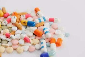 Macro Shot of colour Pills and Capsules During Production and Packing Process on Modern Pharmaceutical Factory. Tablet and Capsule Manufacturing Process. Close-up Shot of Medical Drug Production Line. photo