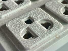 close up of a dirty and white electric socket photo