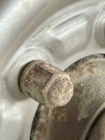 close - up of an old rusty bolt with a hole in the background, selective focus. photo