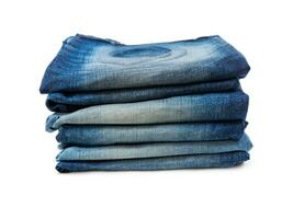 stack of jeans isolated over white background photo