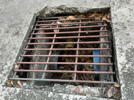 old rusty metal drain on the floor photo