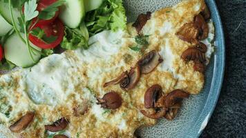 Plain Egg Omelette mixed with mushroom and fresh salad on a plate video