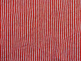 close up red striped fabric background photo
