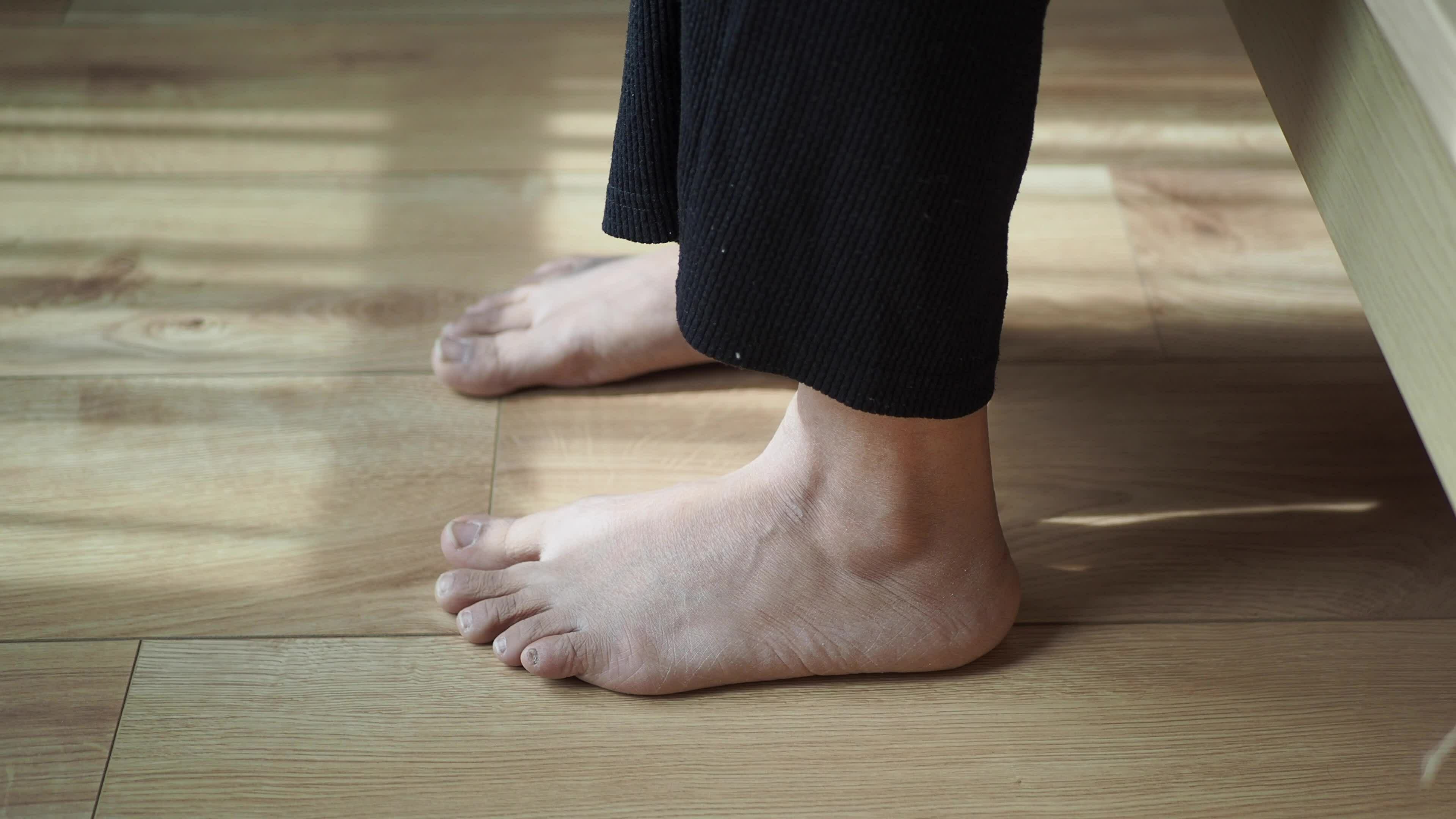 women-hand-message-on-feet-feeling-pain-early-morning-31625586-stock