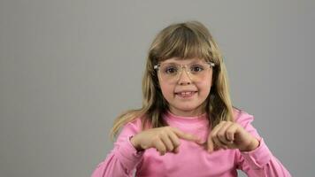 a little girl in glasses pointing at something video