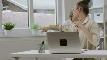 two children wearing sunglasses and standing in front of a laptop video