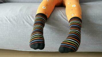 a colorful soft socks on child feet . video