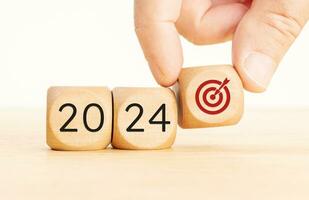 2024 business goals concept. Wooden blocks with 2024 number and goal target icon. Copy space photo