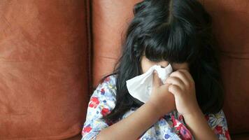 Sick child with flu blow nose with napkin. video