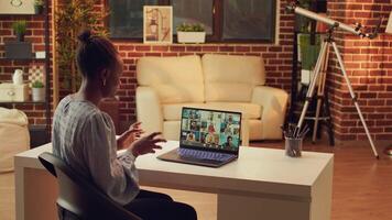 Teleworker attending important meeting online on videocall, using network connection to discuss about executive tasks from home workstation. African american woman on videoconference. video