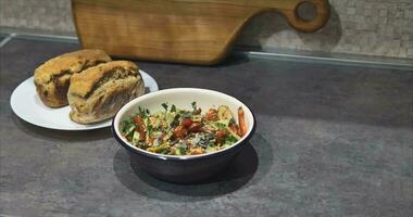 Vegetable salad and fresh bread from the oven on a handmade natural cherry video