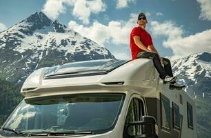 Exploring Scenic Norwegian Landscape From a Camper Van Roof photo