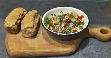 Vegetable salad and fresh bread from the oven video