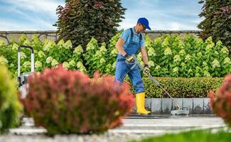 Washing Concrete Bricks Driveway Using Pressure Washer photo