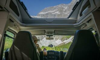 Tourist Inside a Modern Camper Van RV with Panoramic Windows photo