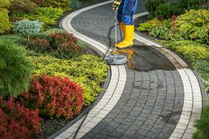 Power Washing Residential Garden Pathway Using Concrete Surface Attachment photo