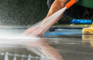 Homeowner Cleaning Patio Poolside Deck photo