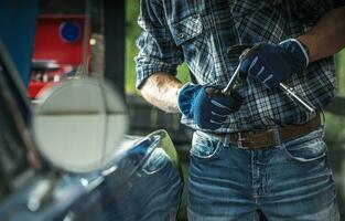 Professional Car Mechanic with a Wrench in His Hands photo