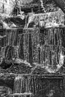 summer landscape with a small waterfall and green trees photo