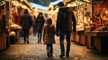 Couple enjoying Christmas market walking near stalls photo